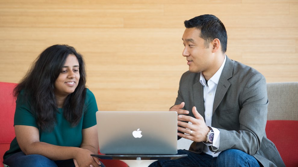 Student and prof sitting in front of a laptop