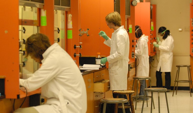 Row of students in a lab with orange lockers