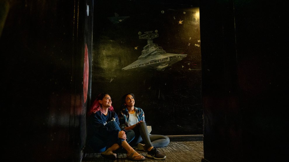 Two students looking up at the night sky.
