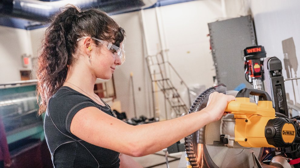 Student in lab using a machine.