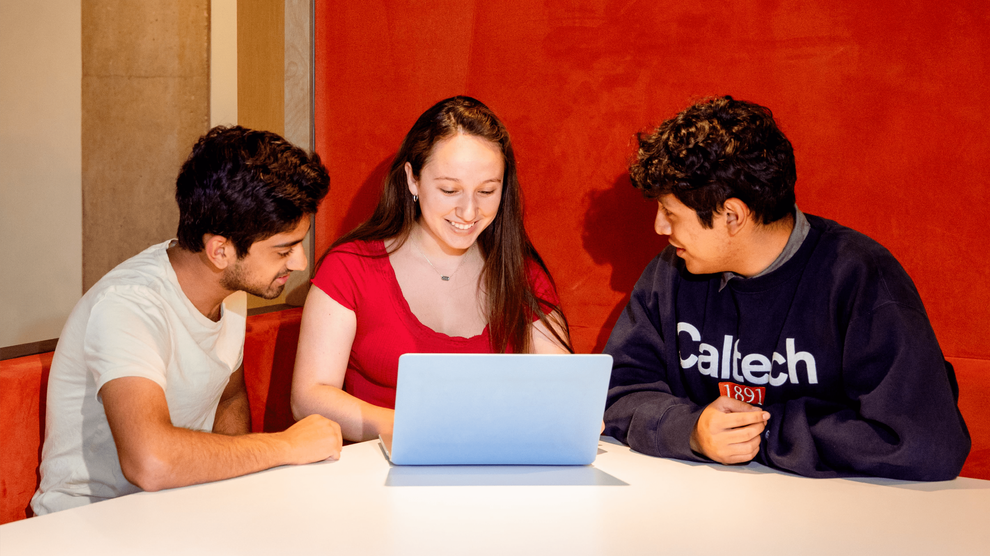 students sitting around laptop