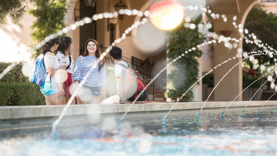 Students chat next to Gene Pool fountain