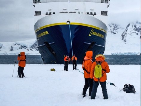 People pull a boat ashore in Antarctica