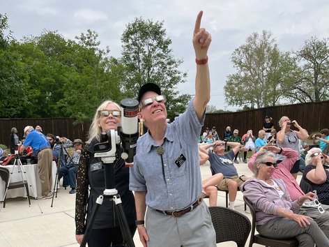 People watching a solar eclipse with safety glasses