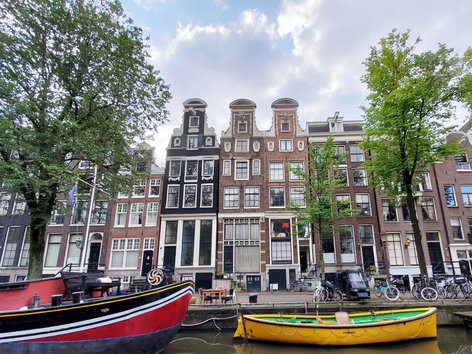 Boats and buildings as seen from a canal in Amsterdam