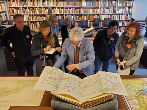 People viewing a large map in a library in Amsterdam