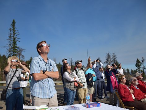 People wearing special glasses to watch a solar eclipse