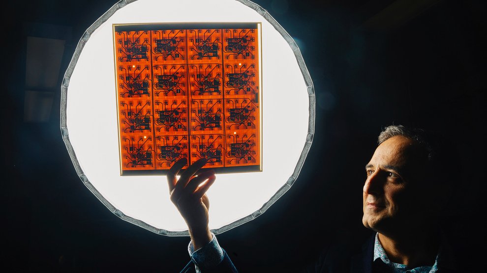 Caltech Professor Ali Hajimiri holds a component of a solar energy collector