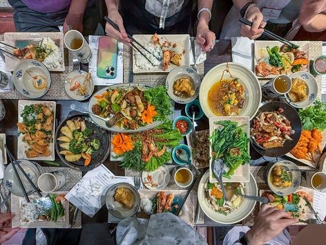 Overhead view of a dining table filled with a variety of Vietnamese cuisine