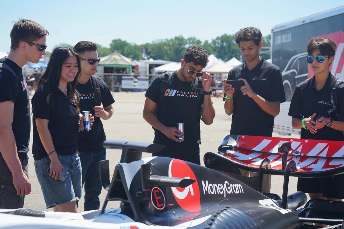 Students looking at a race car