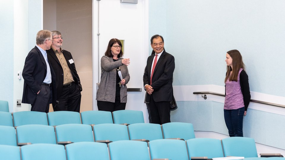 Division chair Fiona Harrison shows a classroom to guests.