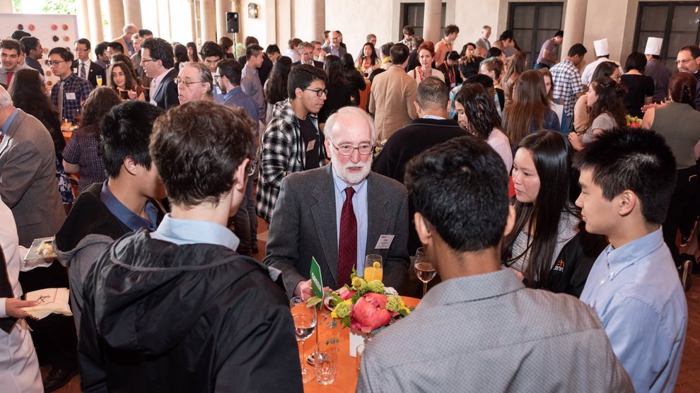 A busy scholarship reception with students, donors, and other friends at the Athenaeum.