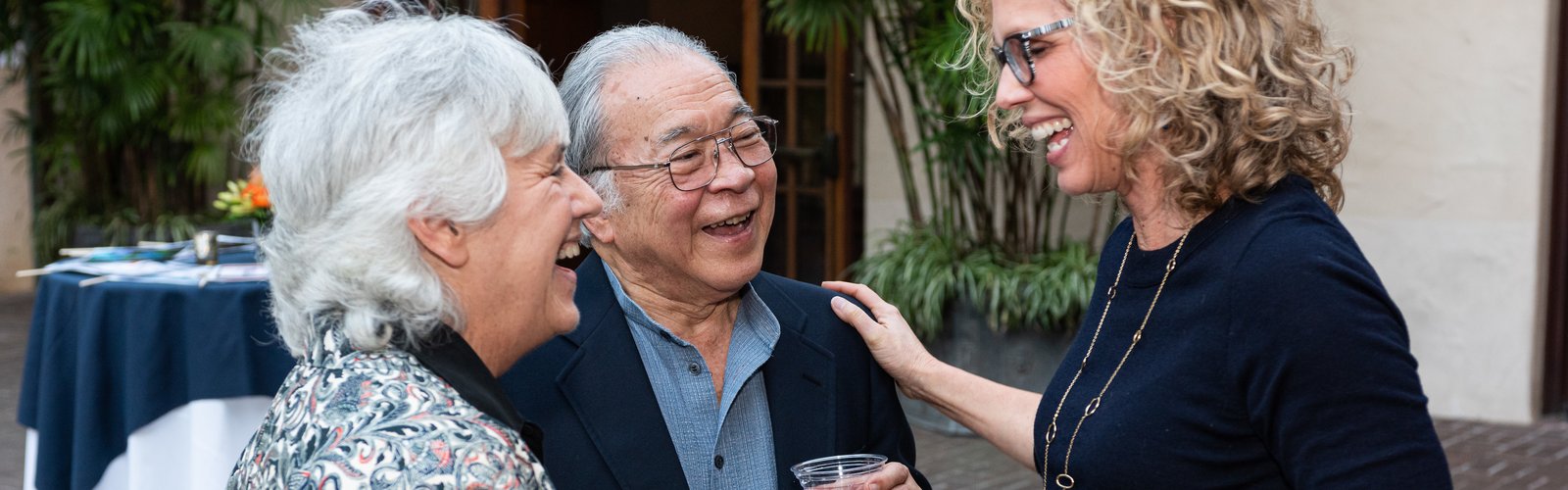 Young woman talking to two older people