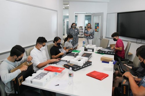 CTLO&#x27;s Cassandra Horii and Kitty Cahalan look on as students at Santa Ana High School receive their new laptops