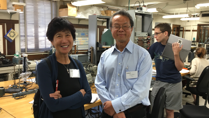 The Fus stand in an undergraduate physics lab