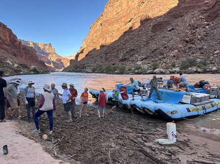 Group loads materials onto a river raft