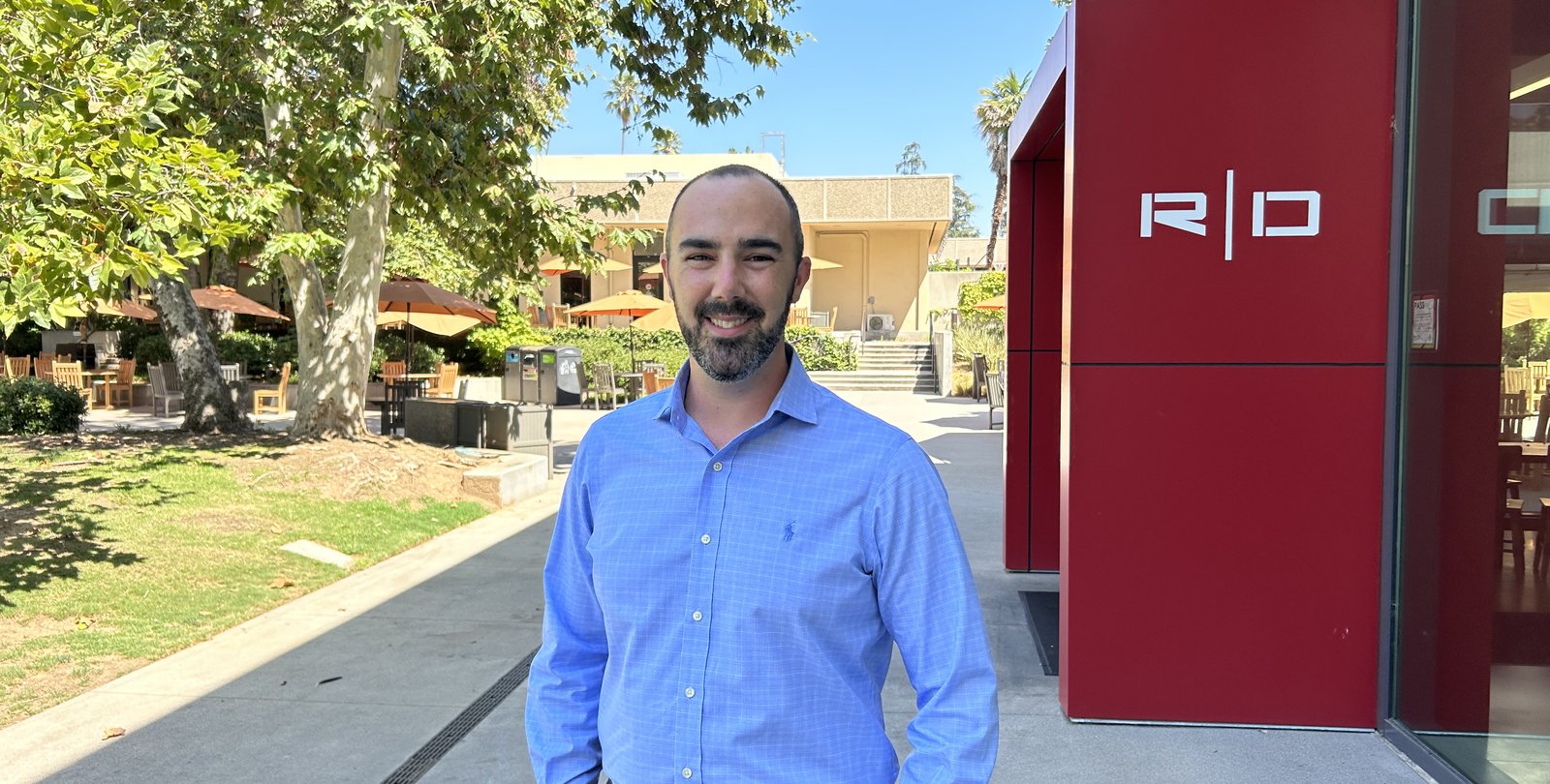Alex Johnson in front of Red Door on campus