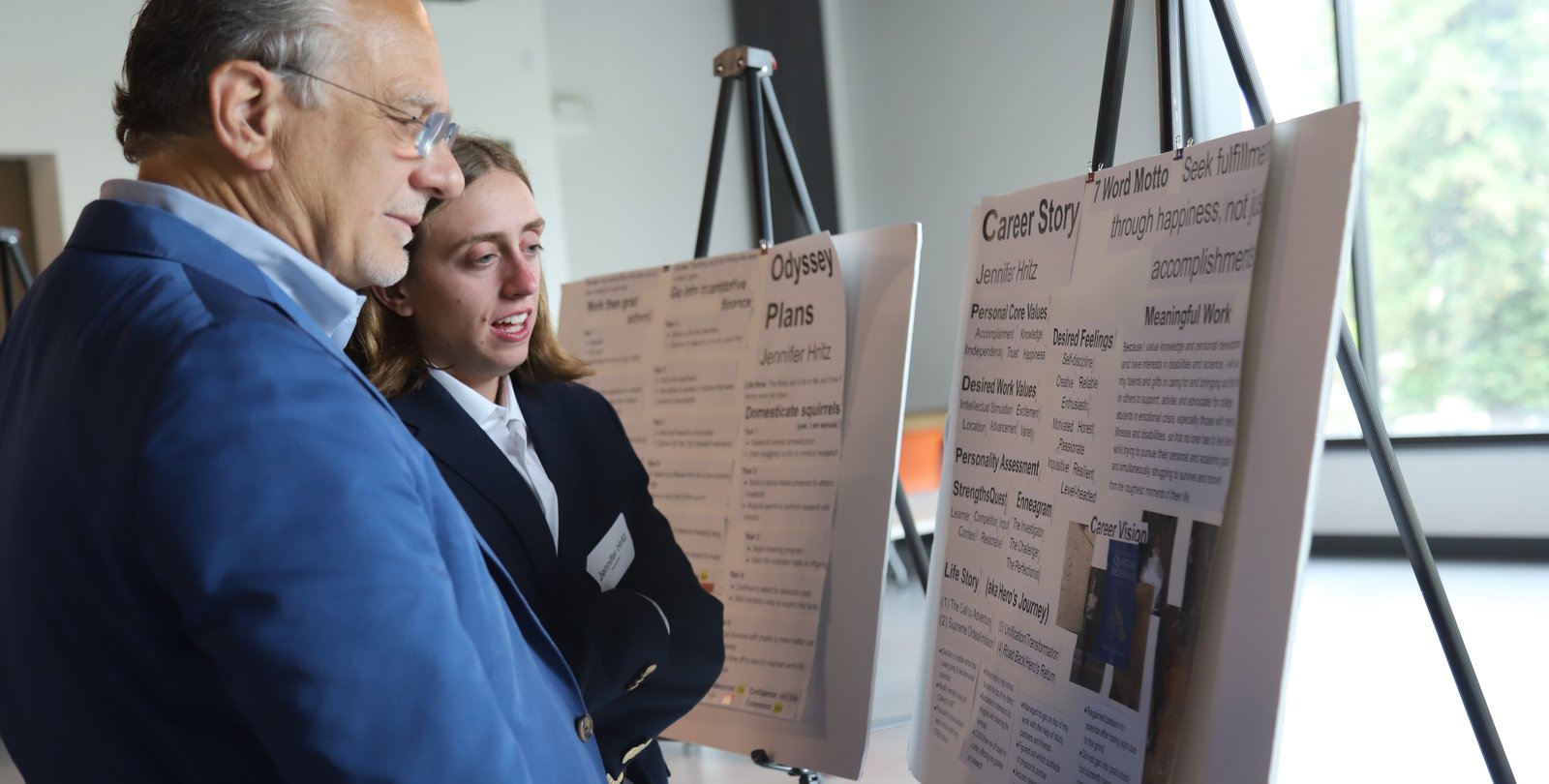 Jennifer Hritz (BS '23), presents her career plan to alumnus Phil Naecker (BS '76) at the 2023 Design Your Career final poster and mentor matching session.
