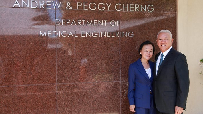 Andrew and Peggy Cherng stand together by the department of Medical Engineering.