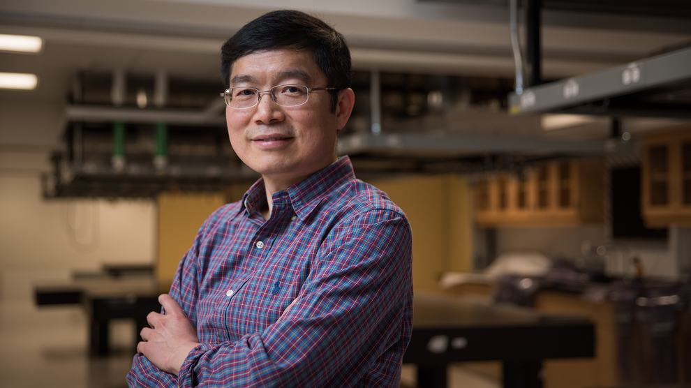 Lihong Wang in a lab smiles.