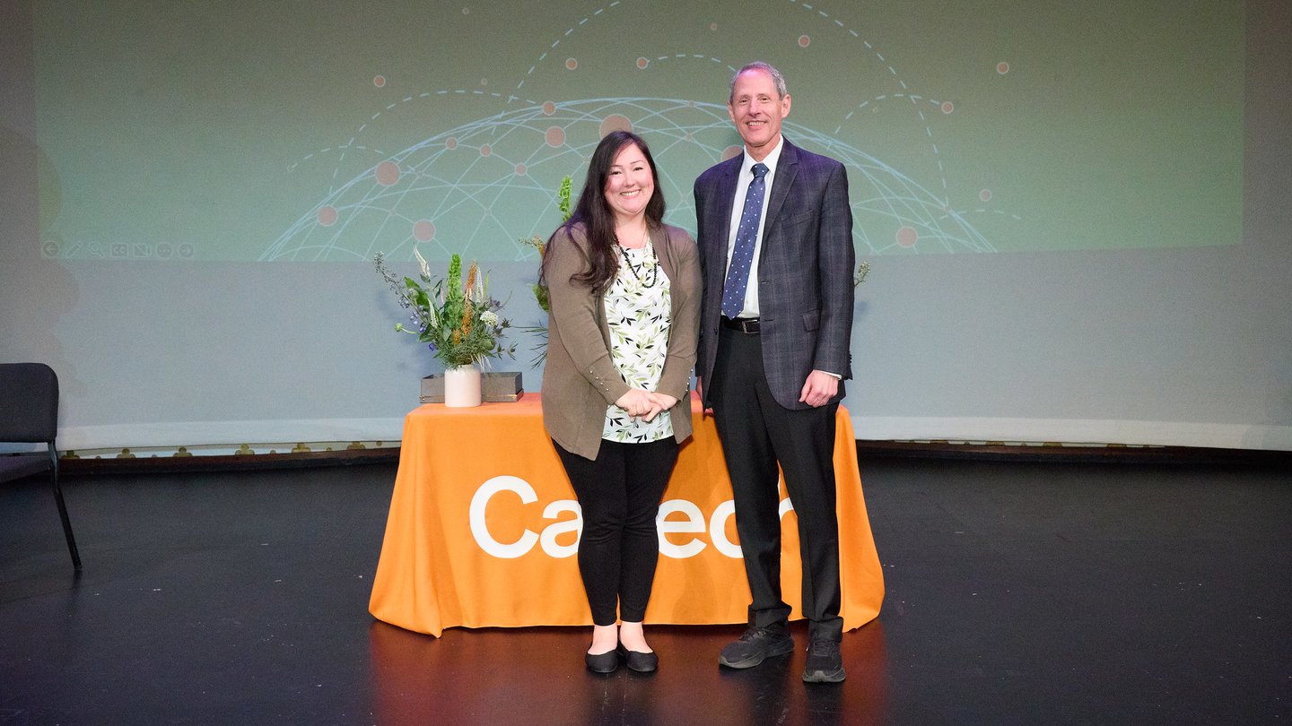 Two people on a stage. L to R Jenni Campbell, Thomas F. Rosenbaum