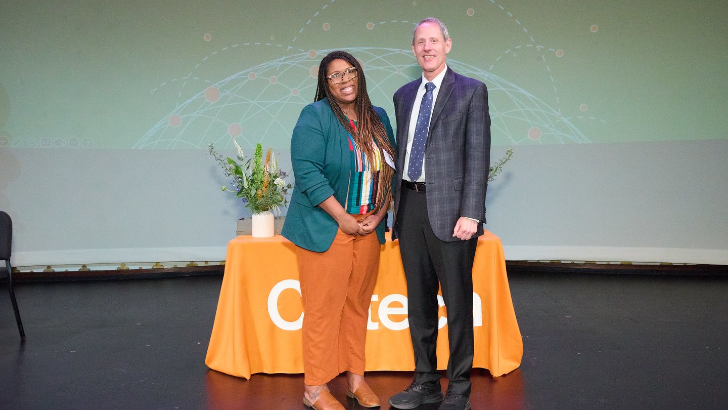 Two people on a stage. L to R Tashiana Bryant-Myrick, Thomas F. Rosenbaum