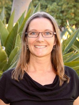 Woman with brown hair and glasses