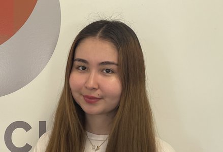 Young woman in front of a logo