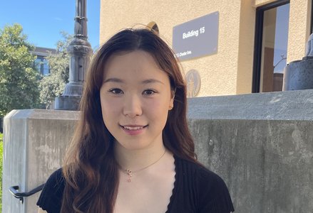 Young Asian woman with long dark brown hair wearing a black blouse