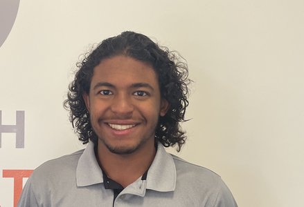 Young man in front of a logo
