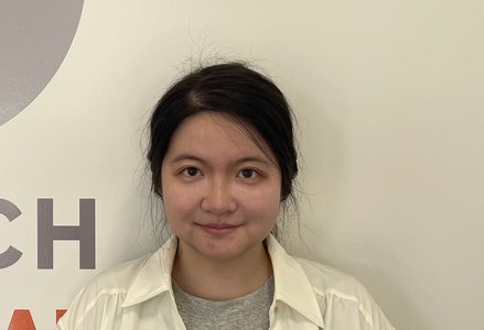 Young woman in front of a logo