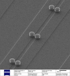 Pairs of gold-capped silicon nanopillars, spaced 50 nm apart, function as a field-emission controlled-plasmonic resonators