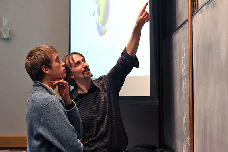 Teachers points to chalkboard