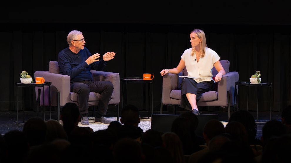 Bill Gates and Amy Harder speaking on Beckman Auditorium's stage