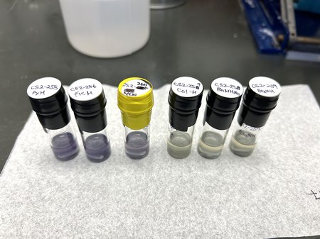 glass tubes with liquid inside and labeled lids