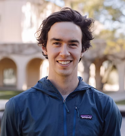 A person in a blue jacket with dark hair
