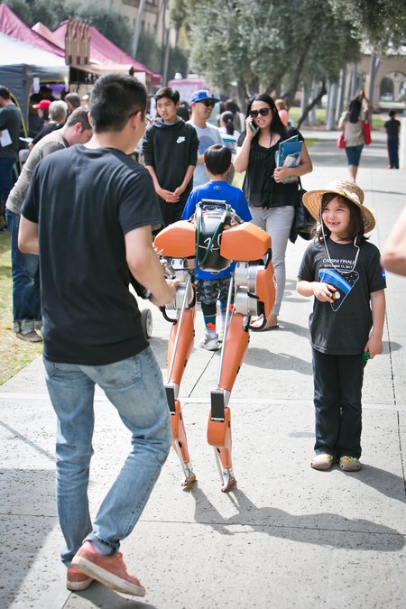 Science for March participant Stella Cook stops to watch a demonstration of Caltech's bipedal robot Cassie at the March 31 event.