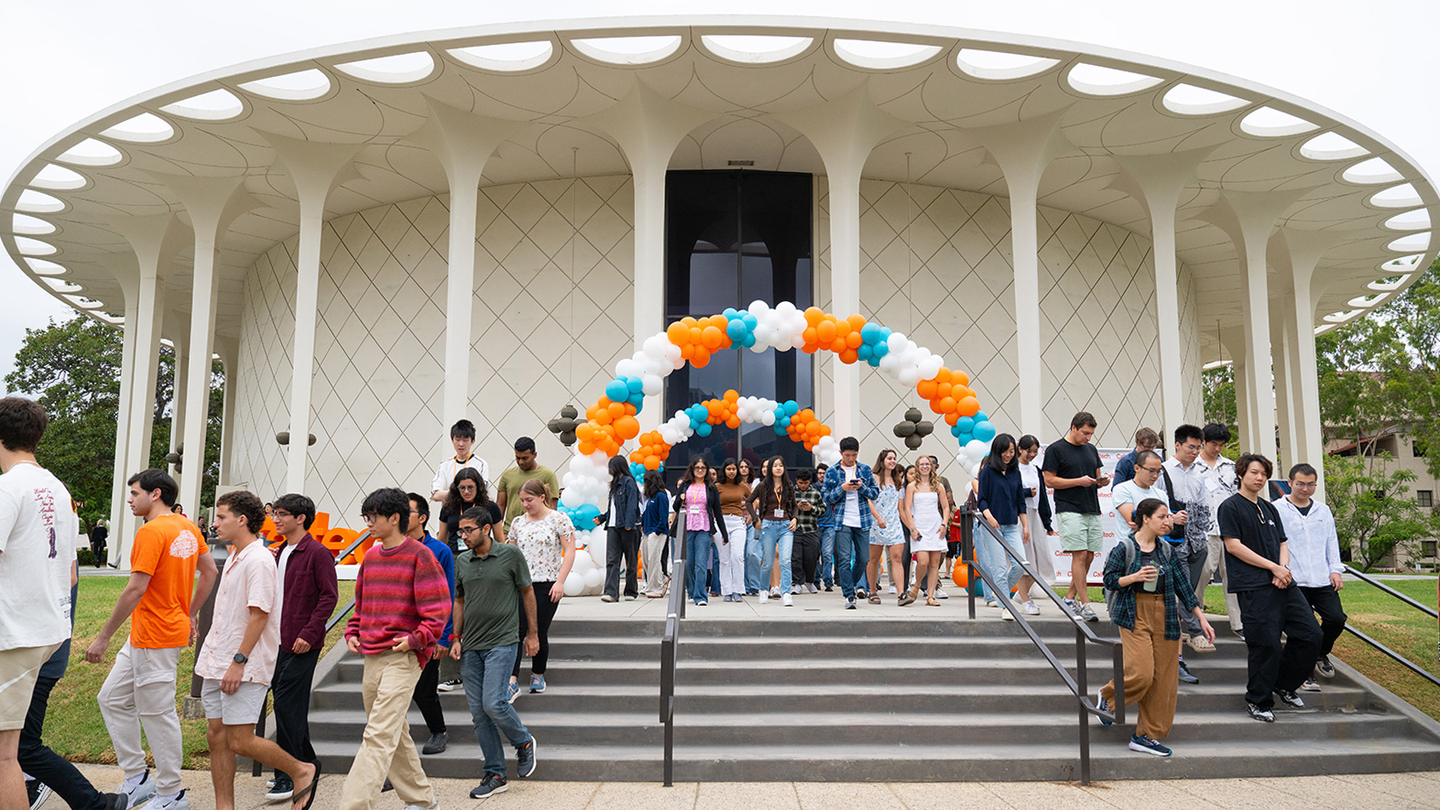 A group of new students exit Beckman Auditorium after Convocation 2025.