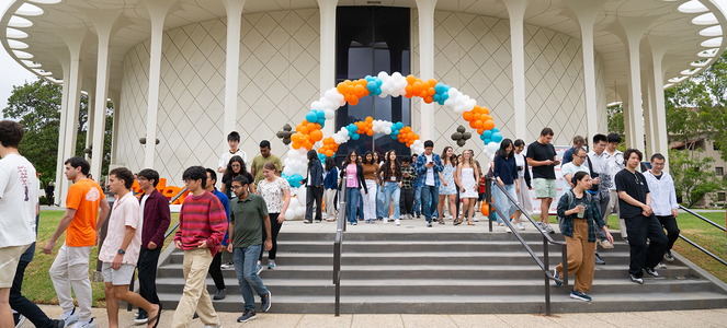 A group of new students exit Beckman Auditorium after Convocation 2025.