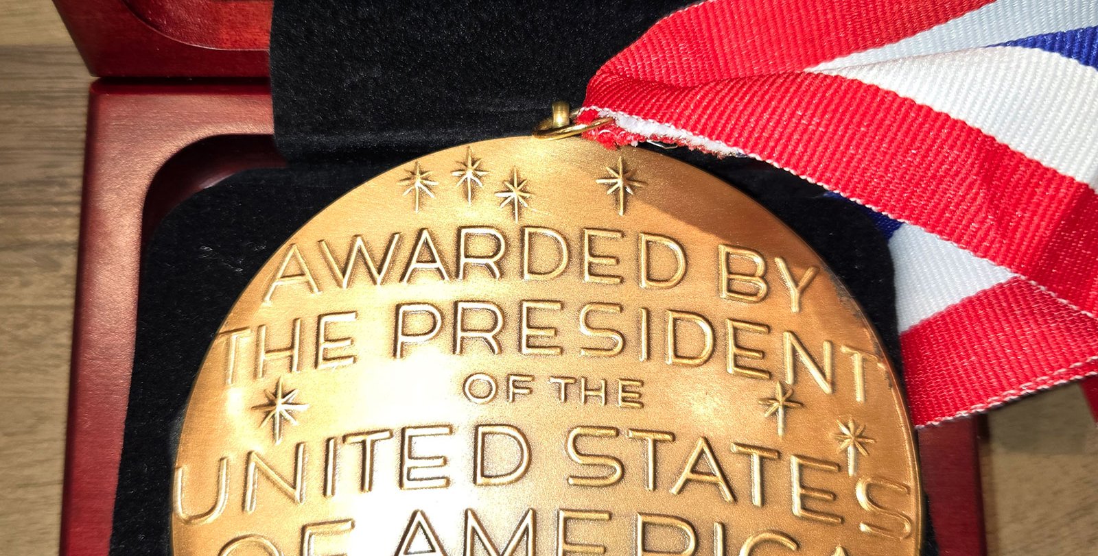 The back side of a National Medal of Science says, "Awarded by the President of the United States of America to John O. Dabiri 2024"