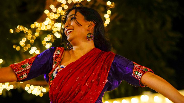 A dancing woman wearing traditional Indian dress