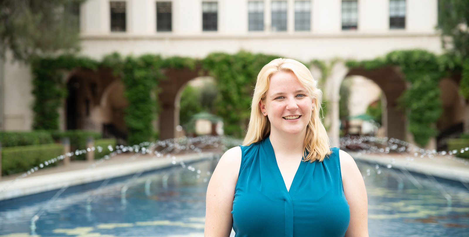 Lily Dove standing in front of the Caltech reflection pool.