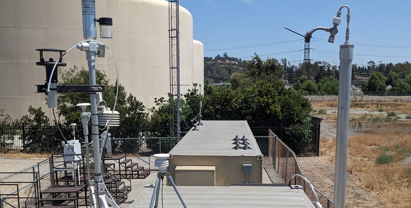 Equipment related to aerosol measuring instruments set up on the roof of a shipping container in Pico Rivera