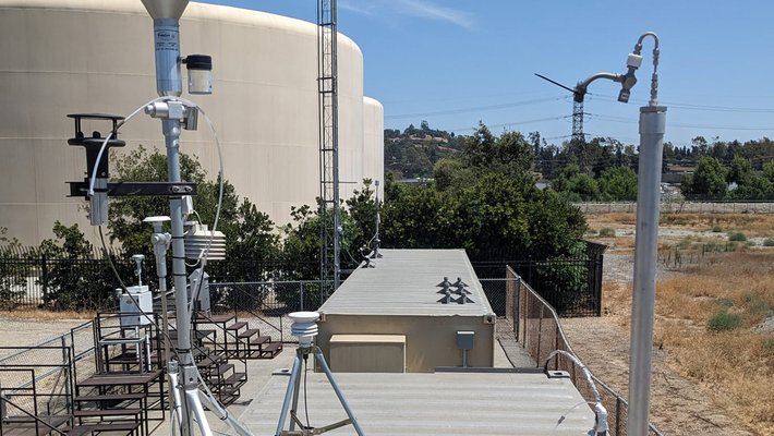 Equipment related to aerosol measuring instruments set up on the roof of a shipping container in Pico Rivera