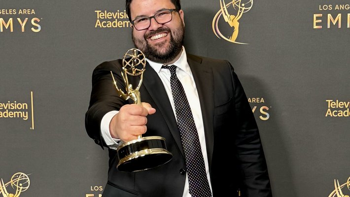 Brandon Bubion holding an Emmy Award
