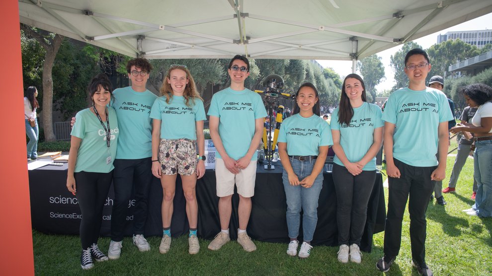 The Caltech Science Exchange AI ambassadors pose with the LEONARDO robot.
