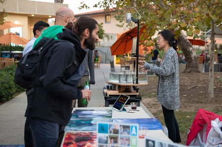 Event attendees check out a "rotating table" experiment that reproduces the influence of Earth's rotation on ocean currents.