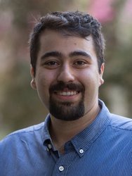 A portrait of Mohammad Mirhosseini. He wears a collared shirt and stands outside.