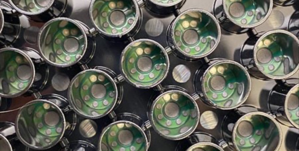 A patterning of cylindrical wells with small green electrodes inside