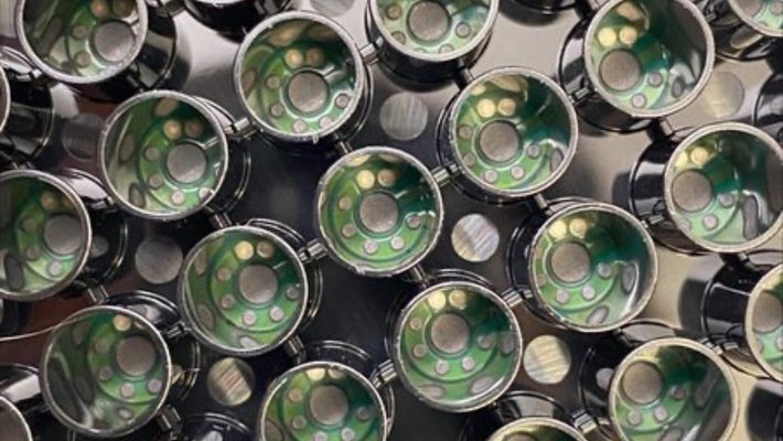 A patterning of cylindrical wells with small green electrodes inside